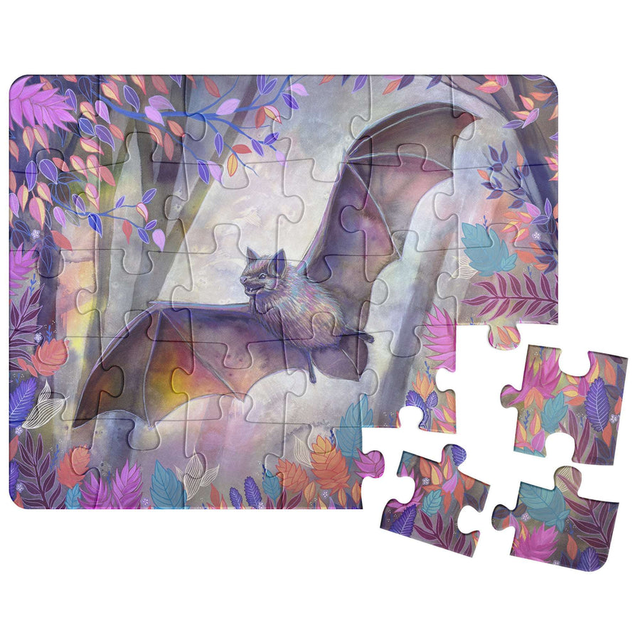 Bat Puzzle depicting a whimsical bat with floral and colorful background, partially assembled with loose pieces nearby.