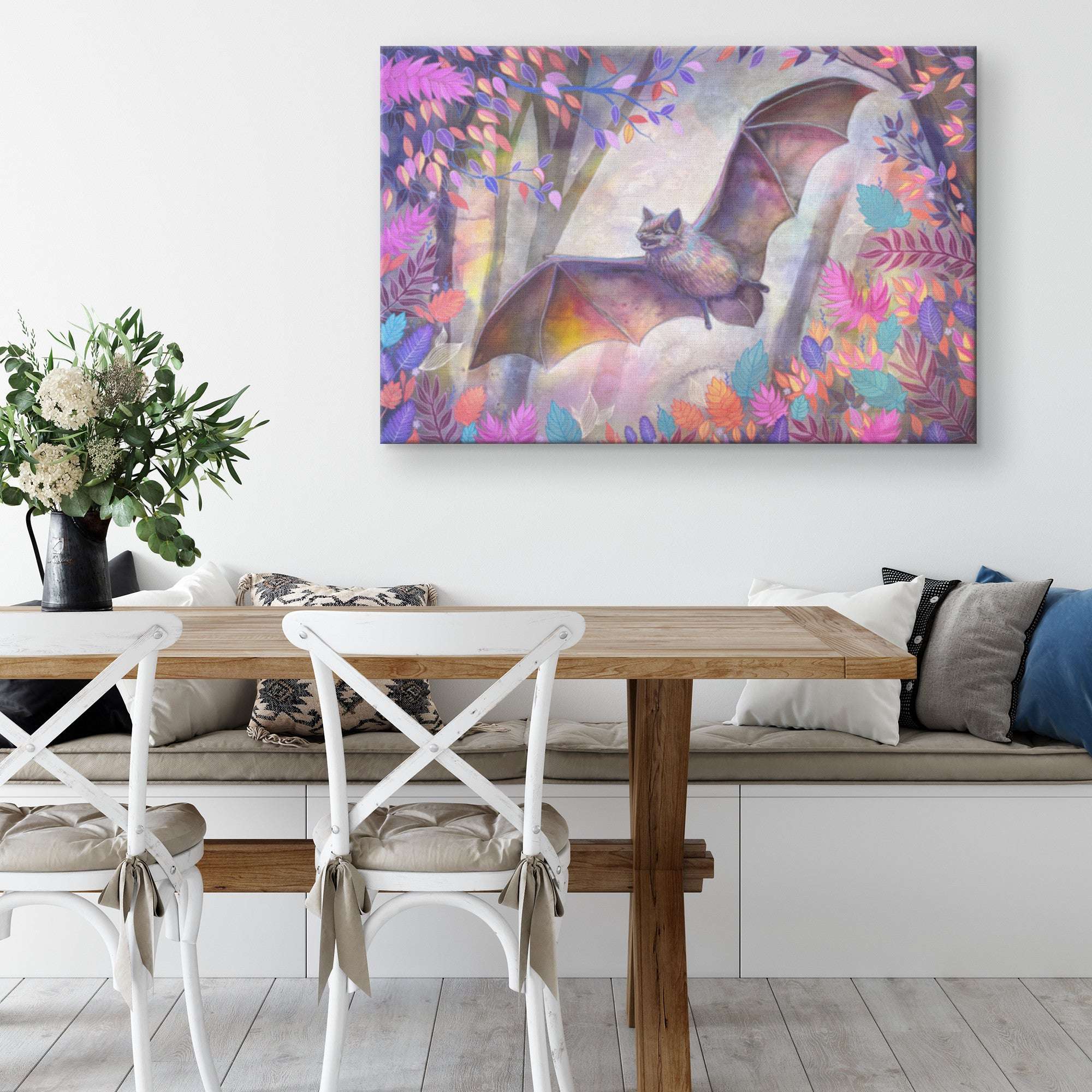 Colorful Canvas Bat Print, displayed above a couch in a modern living room with white chairs and a wooden table.
