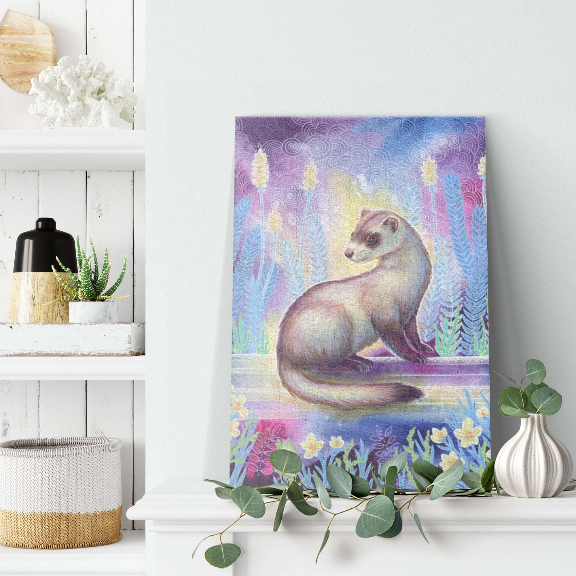 A Canvas Art Print of a ferret in a whimsical forest setting, displayed on a white wall above a shelf with decorative items.