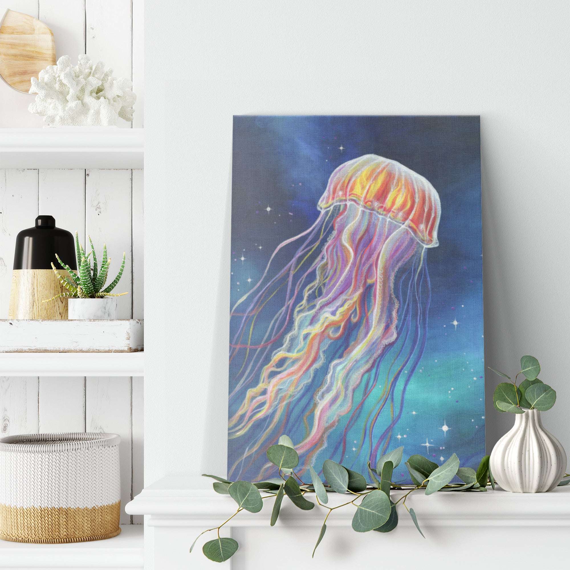 A jellyfish canvas art print, displayed on a white shelf alongside decorative items, in a bright, modern room.