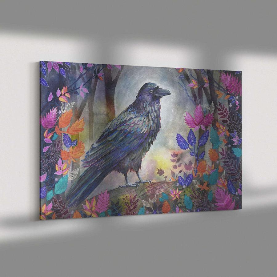 A Canvas Raven Print featuring a colorful illustration of a raven amid vibrant, multicolored leaves and flowers, displayed on a gray wall.