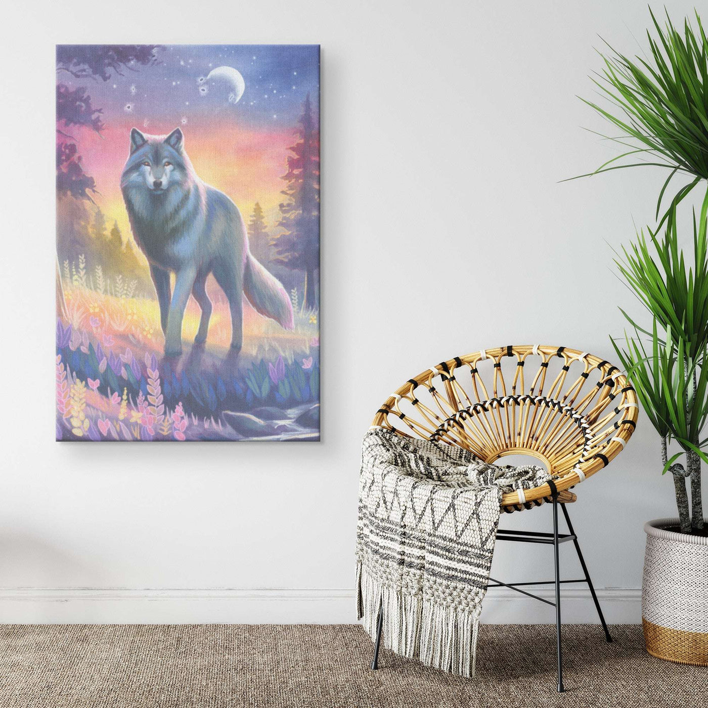 A Canvas Wolf Art Print of a wolf in a mystical forest hangs on a wall beside a wicker chair with a decorative throw.