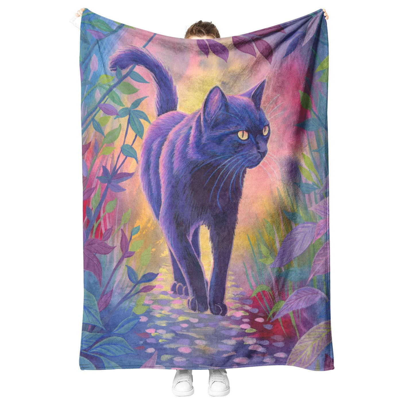 Person holding up a Cat Blanket featuring a black cat walking on a colorful path surrounded by vibrant floral designs.