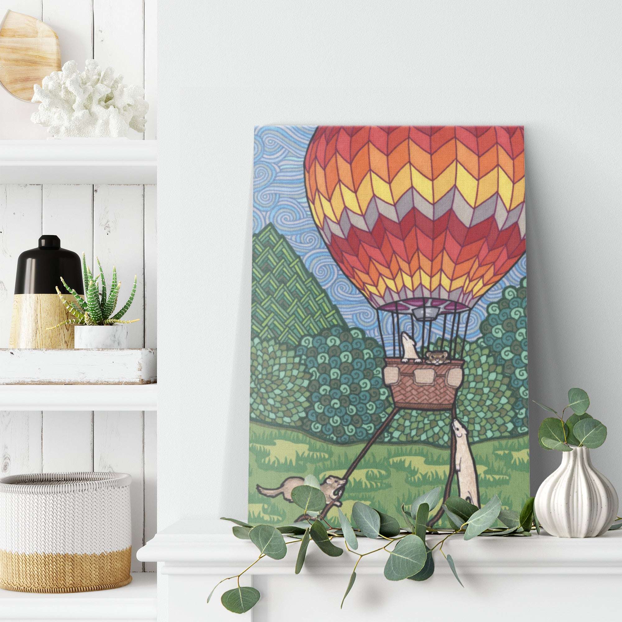 A colorful Ferret Flight Canvas Print of a colorful hot air balloon above a green landscape, with ferrets in the basket and whimsical fun patterns.