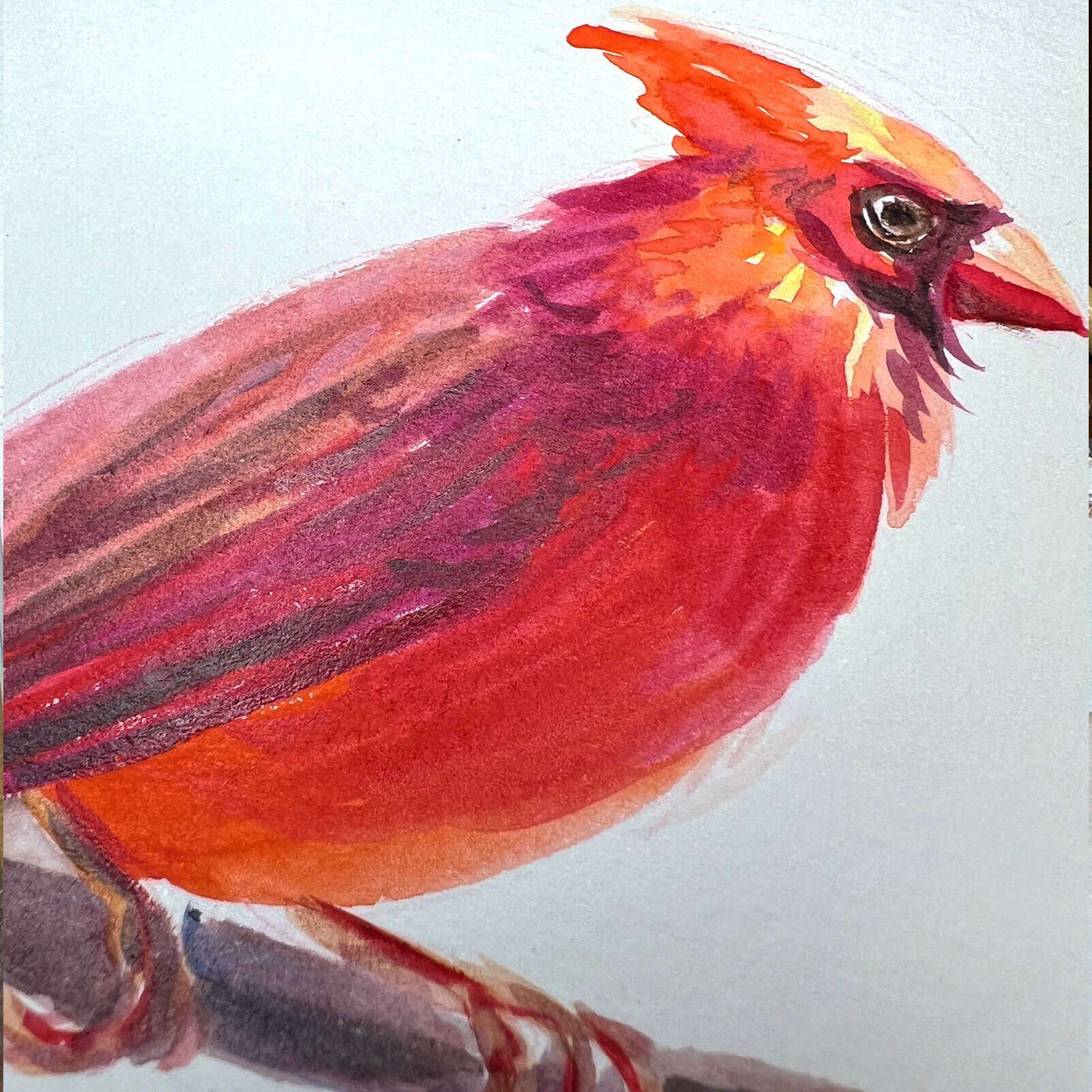 Detailed close-up of a watercolor cardinal's fiery red feathers and keen gaze