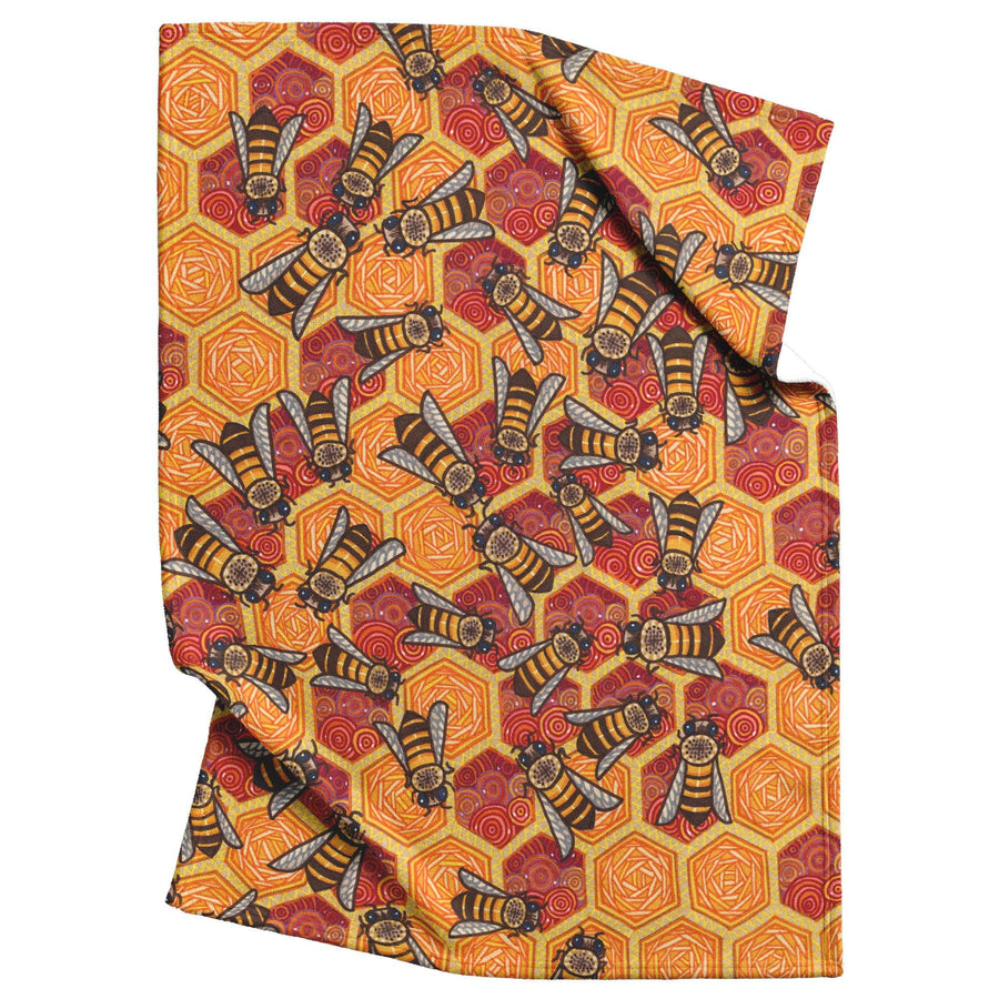 Honeycomb Harmony Blanket featuring a repetitive design of bees and hexagonal shapes on a red ornate background.