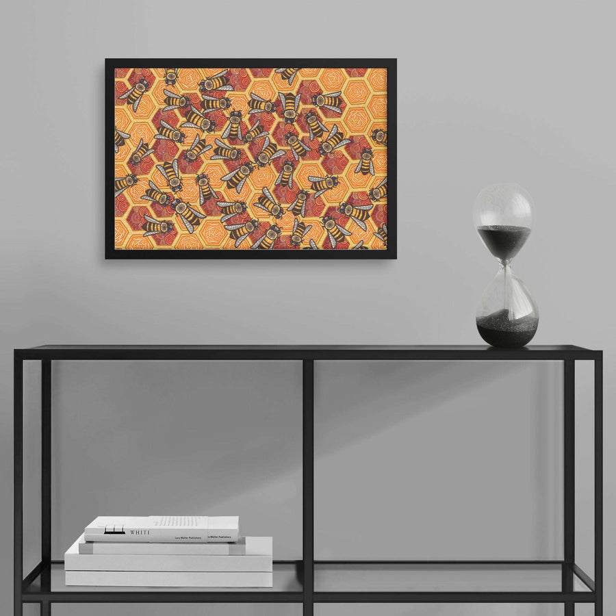 An ornate, colorful Honeycomb Harmony Framed Print hangs above a shelf holding books and an hourglass in a modern interior.