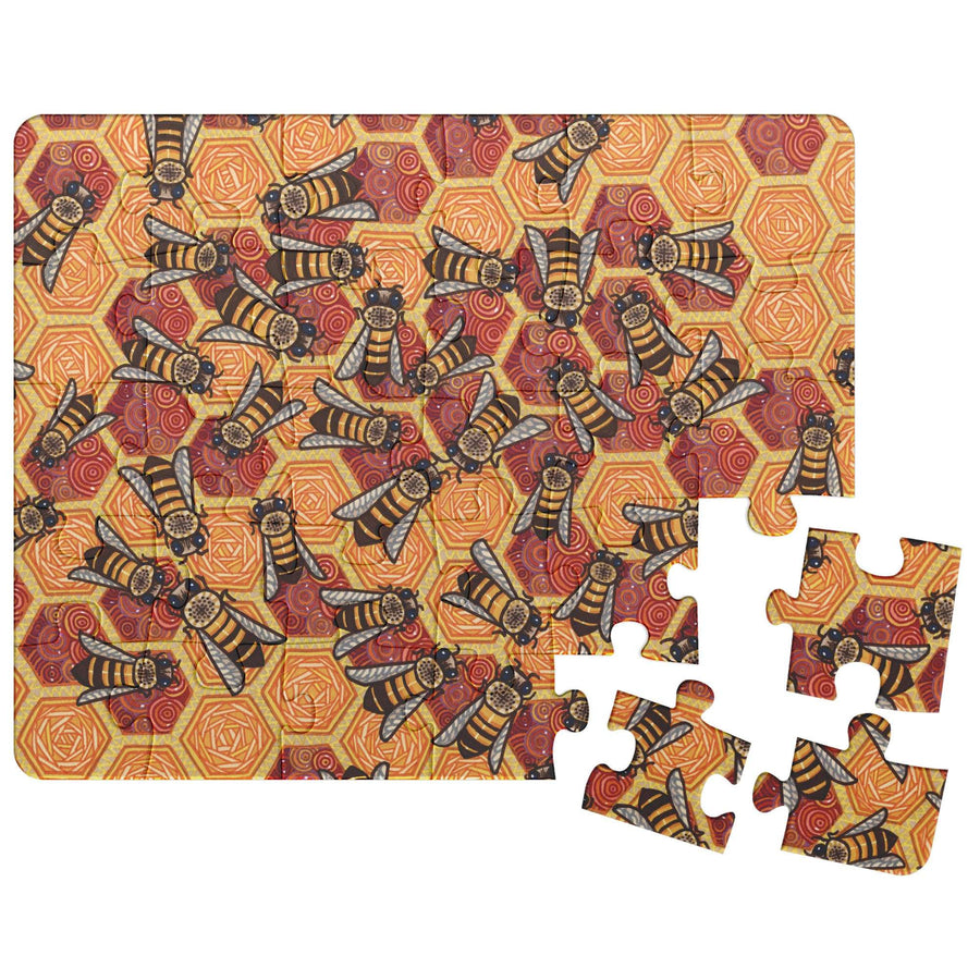 Honeycomb Harmony Puzzle with a detailed bee pattern on a geometric orange background, partially completed with loose pieces nearby.