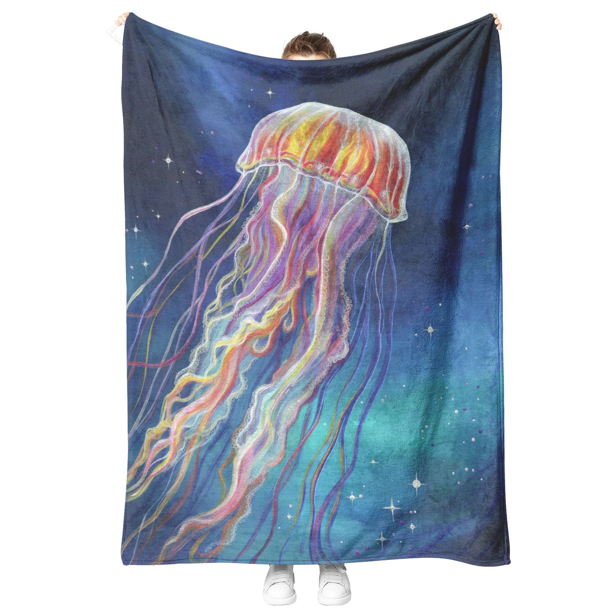 Person holding up a Jellyfish Blanket with a vibrant jellyfish design against a cosmic, starry background.