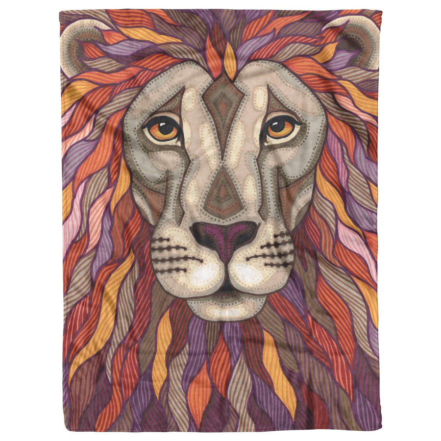 A blanket with an illustration of a lion's face with a colorful, detailed mane composed of various hues of purple, orange, and yellow.