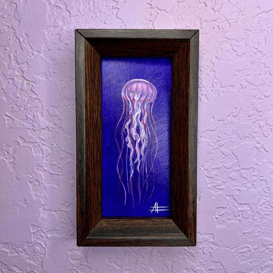 A framed mini painting of a pink jellyfish with delicate tendrils against a deep blue background.
