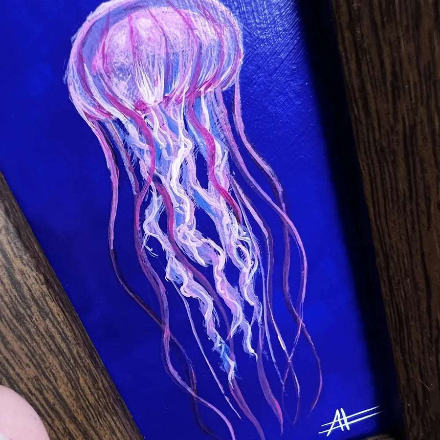 Close-up of a jellyfish painting showcasing the transparent tendrils and vibrant colors.