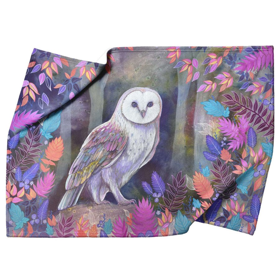 A decorative Owl Blanket featuring a printed design of a white owl surrounded by colorful leaves.