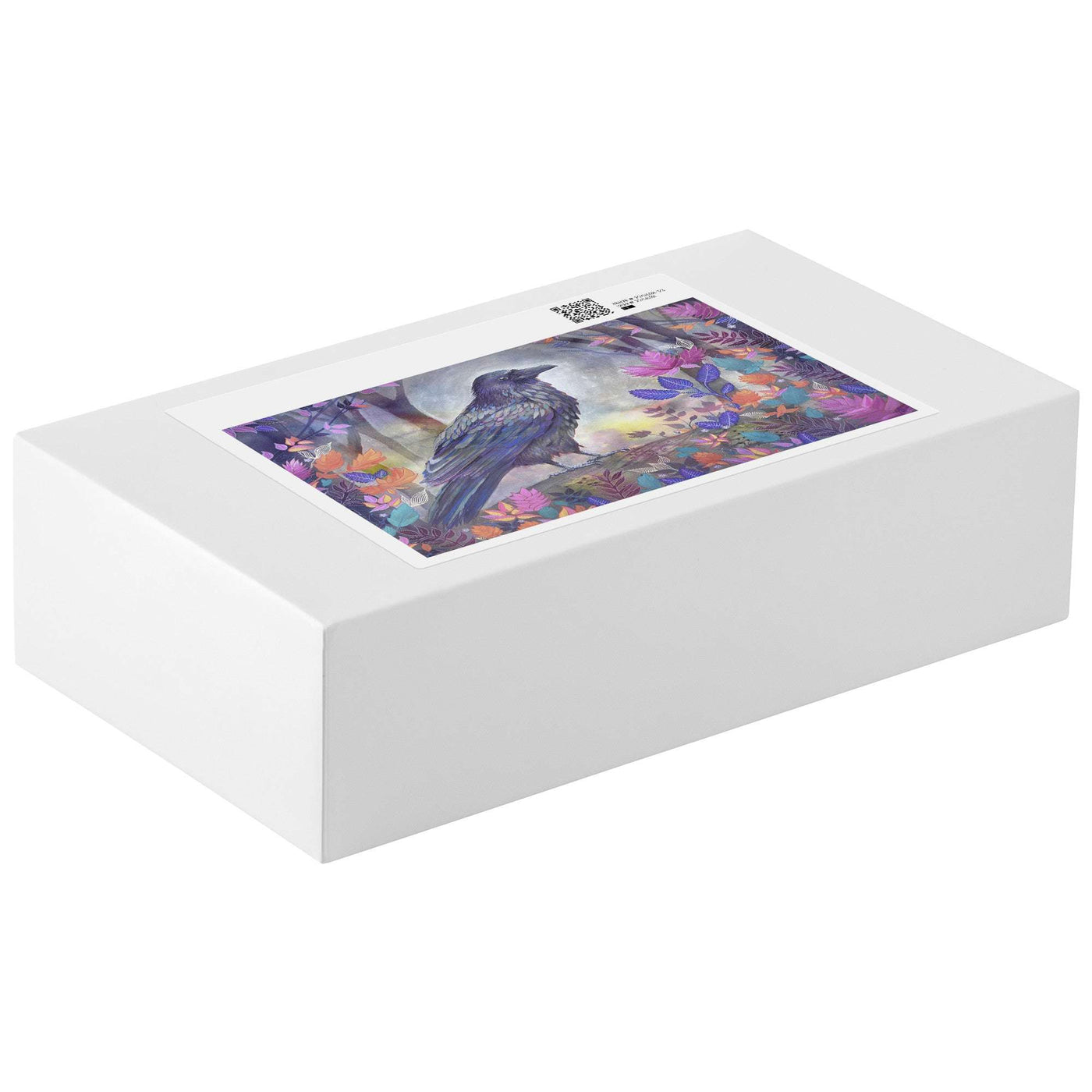 A white Raven Puzzle box showing a vibrant image of a black bird among colorful flowers on it's lid