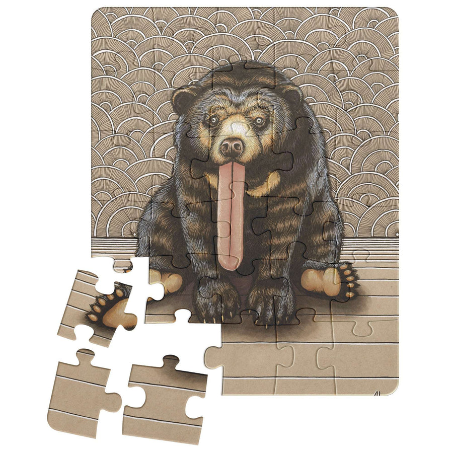 A partially completed Sun Bear Puzzle depicting a bear sitting with its tongue out against a patterned background.