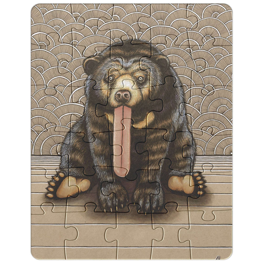 Sun Bear Puzzle featuring a seated bear with a protruding tongue, set against a background of stylized waves.