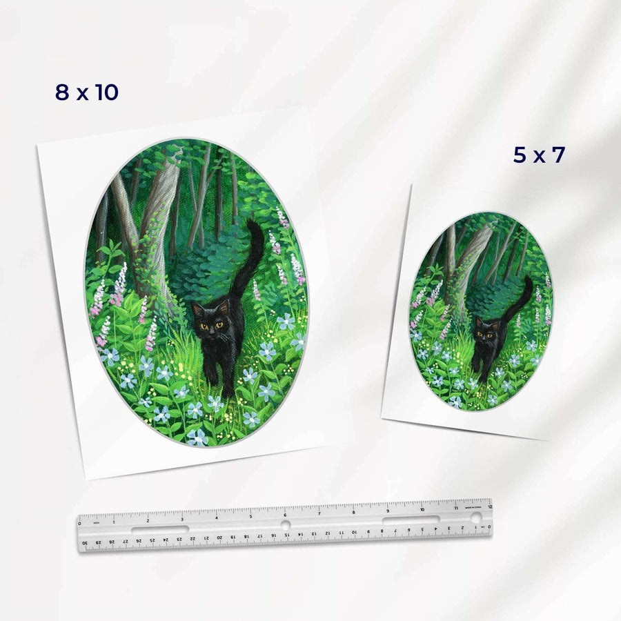 Two Whiskered Welcome - Fine Art Prints of a black cat walking in a lush, green forest depicted in ovals; sizes 8x10 and 5x7 inches shown with a ruler for scale.