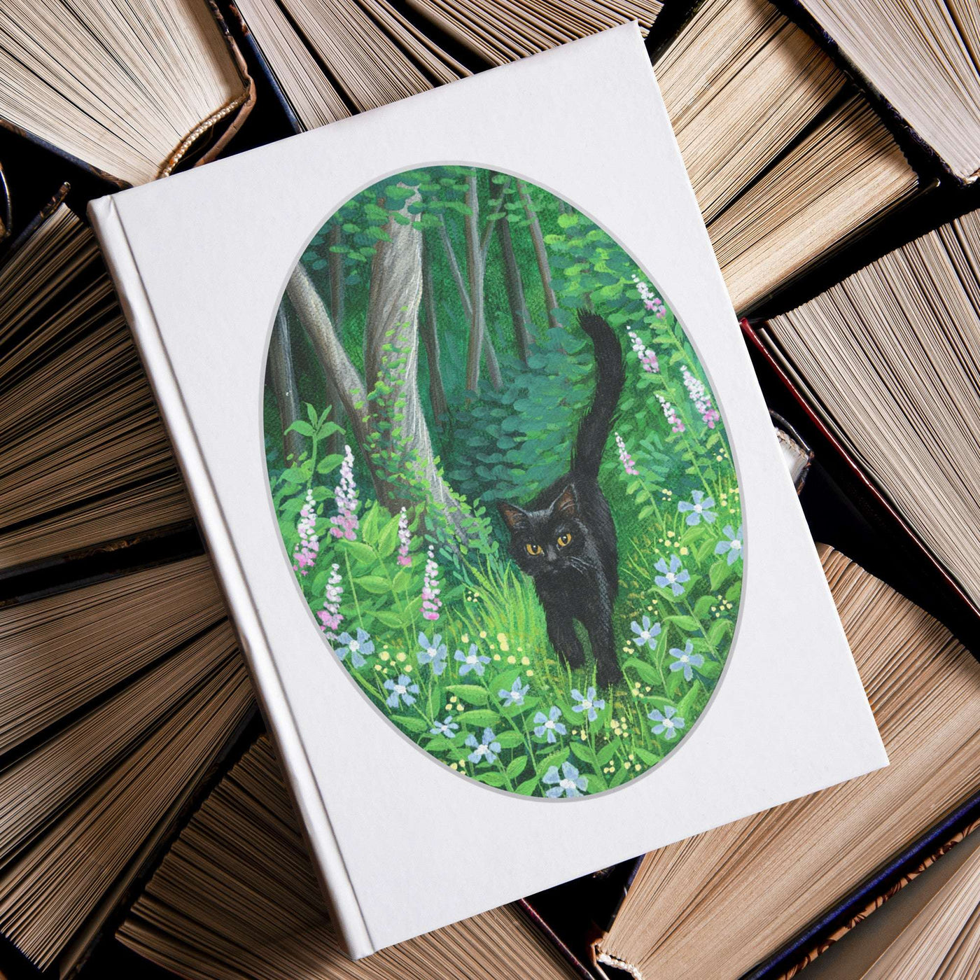 A Whiskered Welcome Journal with a cover illustration of a black cat in a lush green forest, surrounded by stacks of old books.