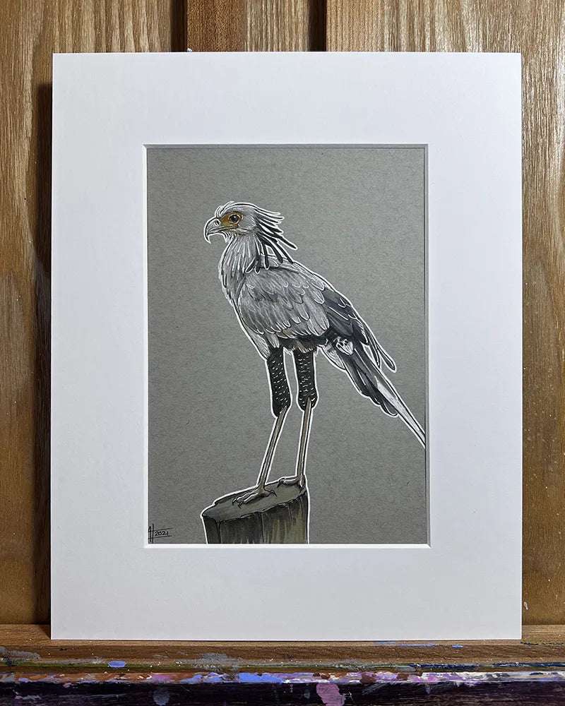 A matted marker and pen illustration of a Secretary Bird perched on a stump, displayed against a wooden easel