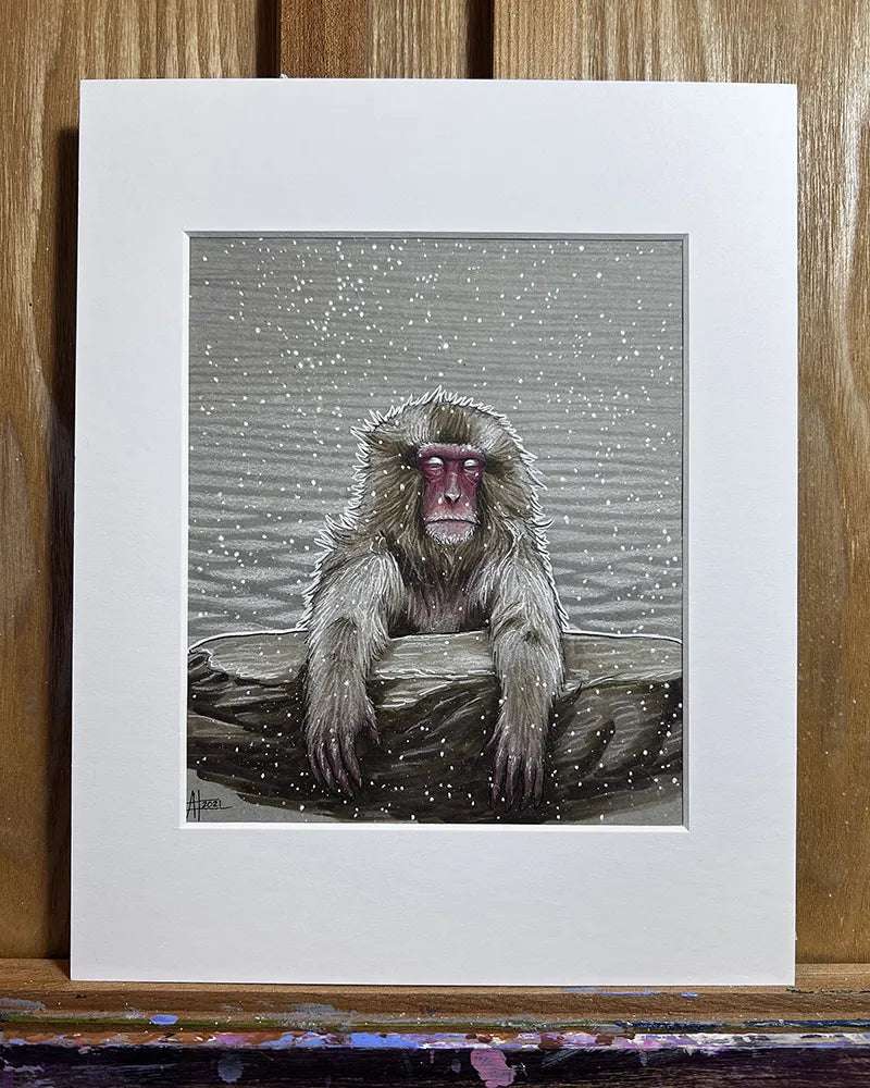 Illustration of a Snow Monkey - Original Marker Painting sitting calmly in a hot spring, surrounded by falling snow, displayed in a white mat against a wooden easel background.