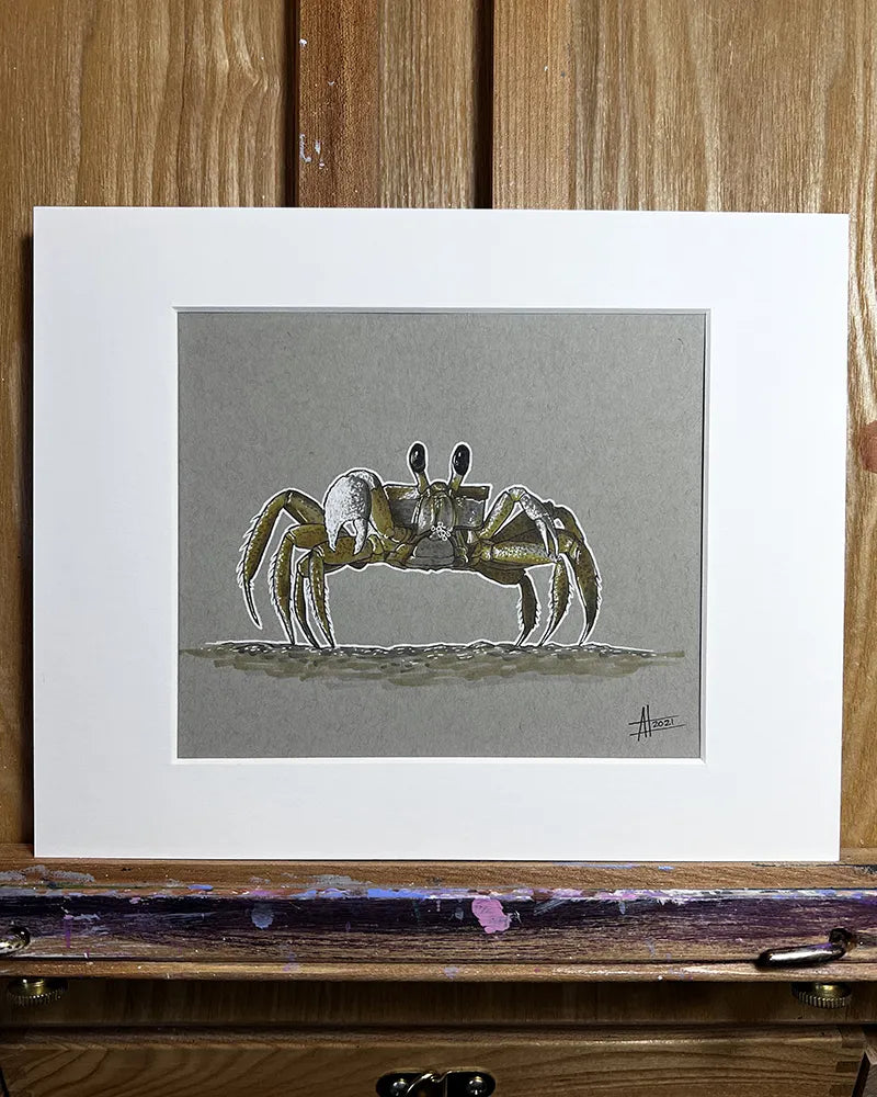 Framed artwork of a Yellow Crab - Original Marker Painting on a grey background, displayed on a wooden easel with paint smudges.