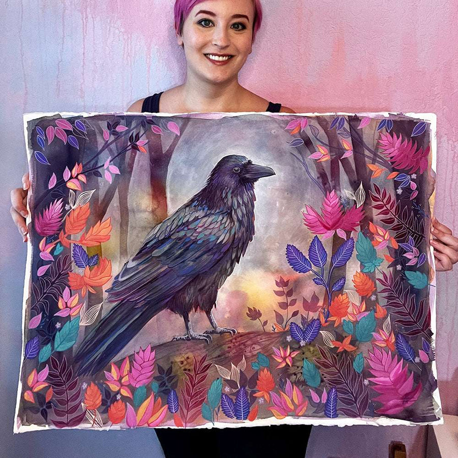 A woman with short purple hair holds a large, colorful painting of The Raven (Night Flight) surrounded by vibrant leaves and flowers.