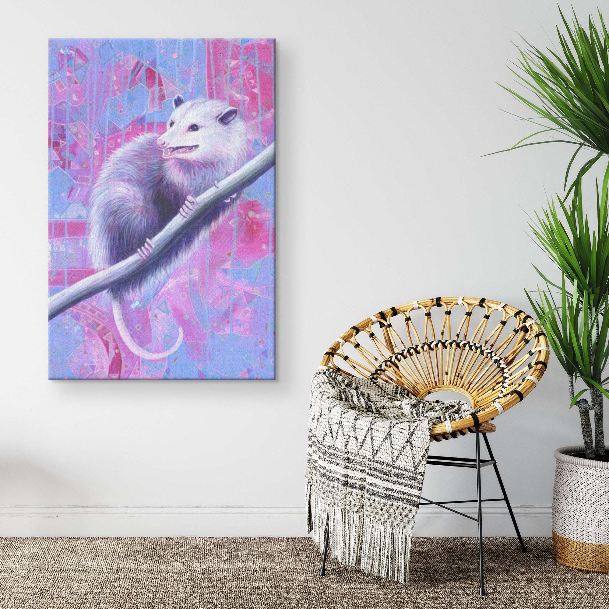 Colorful painting of an Opossum Canvas Print on a branch, set against a graffiti-style background, hanging in a modern room next to a wicker chair with a patterned blanket.