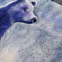 Close-up of a watercolor bear art print with a glittery starry sky backdrop.