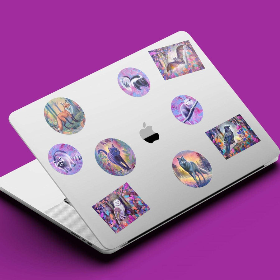 Laptop decorated with circular and square wildlife stickers on a purple background.