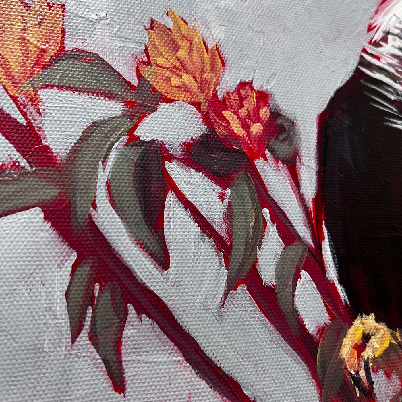 Texture-focused close-up of painted flowers in a caracara bird painting.