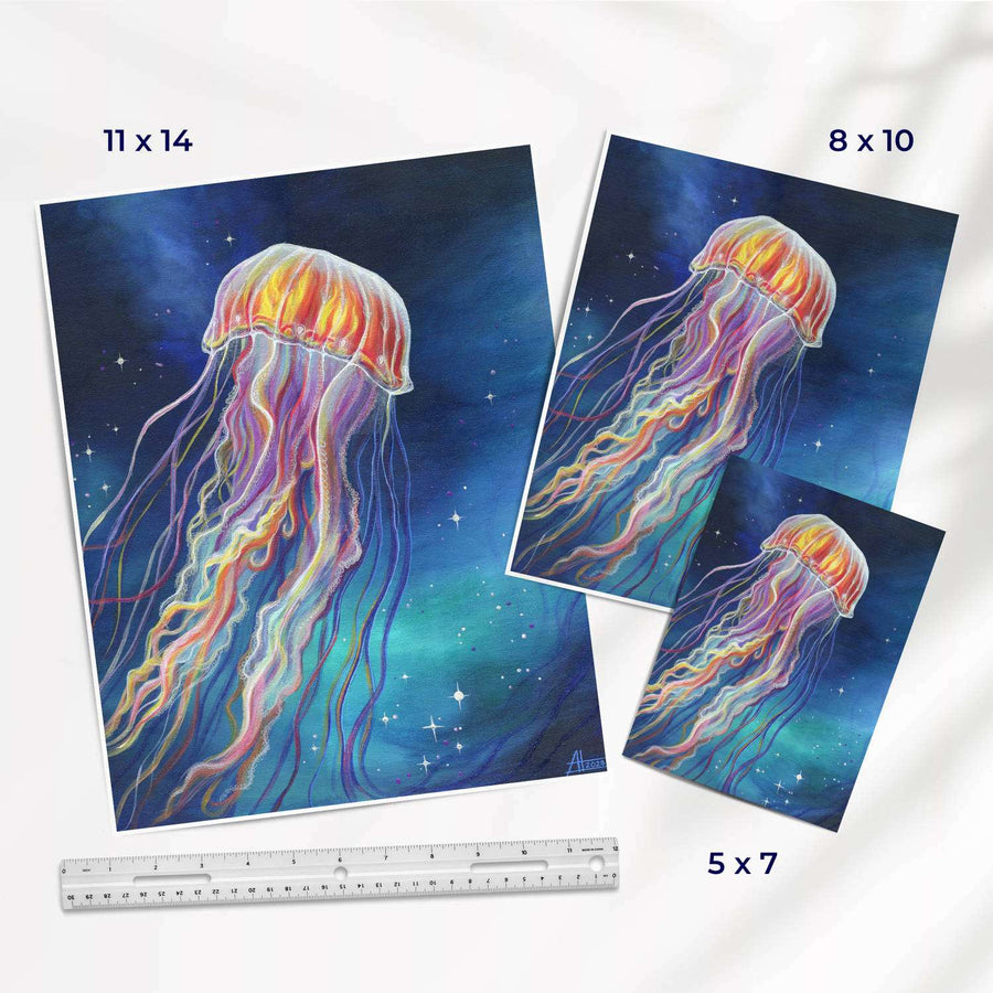Assorted sizes of jellyfish art prints next to a ruler for scale comparison.