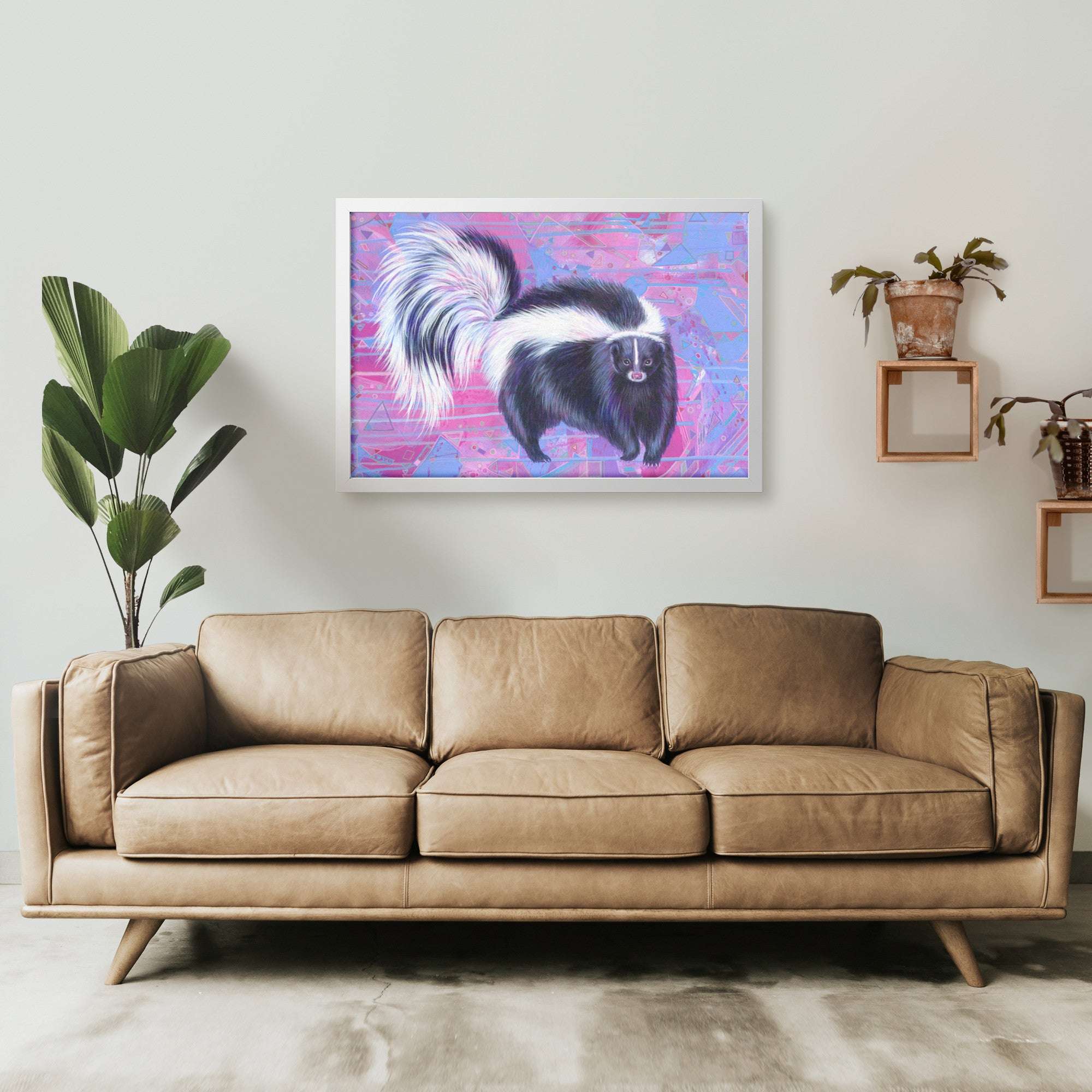A modern living room featuring a Framed Skunk Art Print on the wall, with plants and shelves on either side.