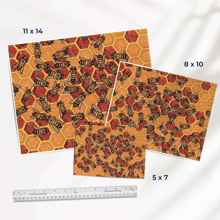 Art prints of bees on honeycomb in different sizes with a ruler for size reference