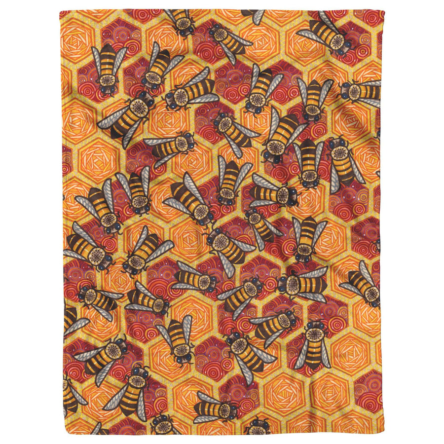 Honeycomb Harmony Blanket featuring a repetitive pattern of stylized bees and hexagonal shapes in warm orange and yellow tones.