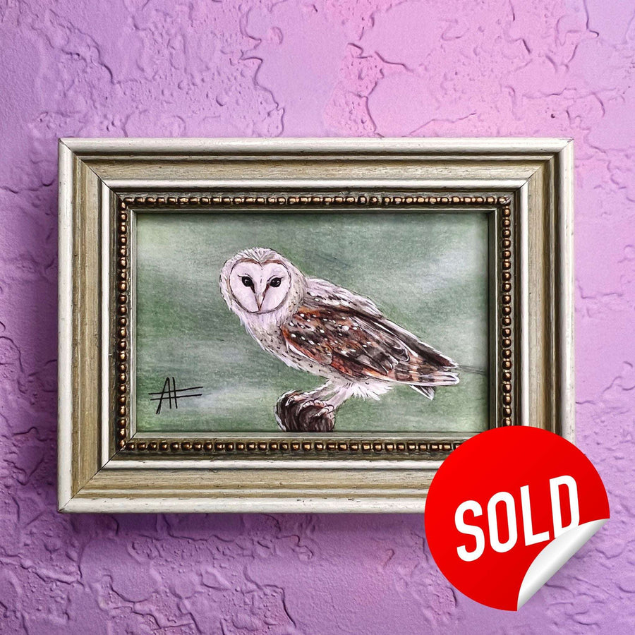 Detailed owl art in a gold frame on purple textured background marked as sold.