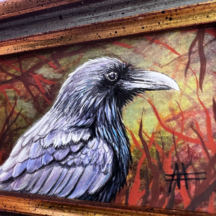Detailed close-up of a raven painting in a rustic frame, showcasing its dark plumage.