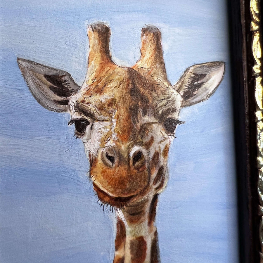 Close-up of giraffe painting capturing its gentle eyes and patterned neck.