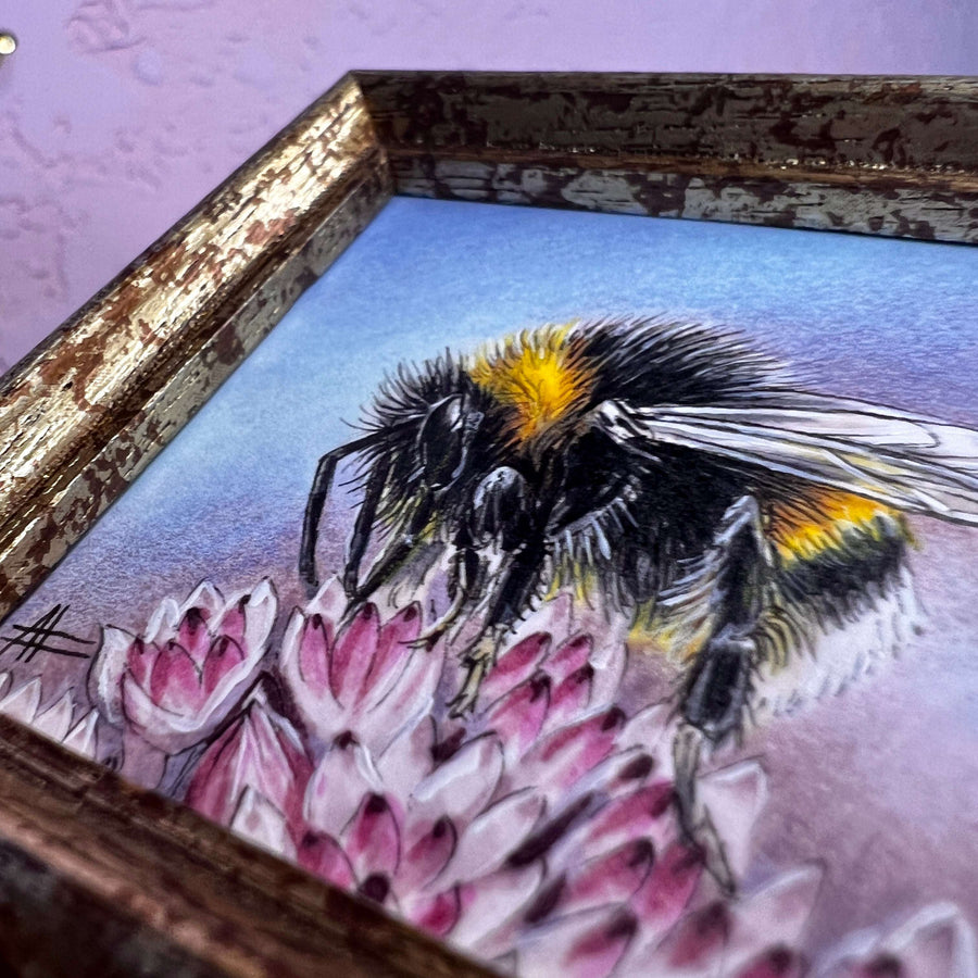 Detailed view of a mini bumblebee painting, highlighting its wings and the pink flower petals.
