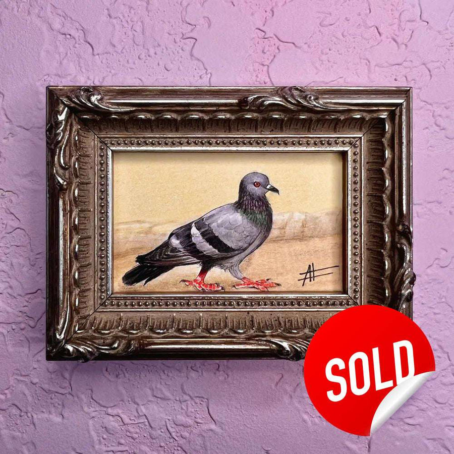 Ornate framed tiny painting of a pigeon on a beige background, marked sold on a purple wall.