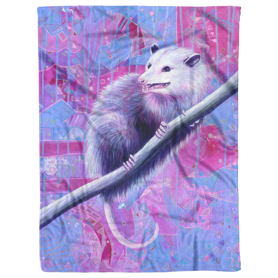 An Opossum Blanket featuring a white possum clutching a branch, set against a colorful abstract geometric background.