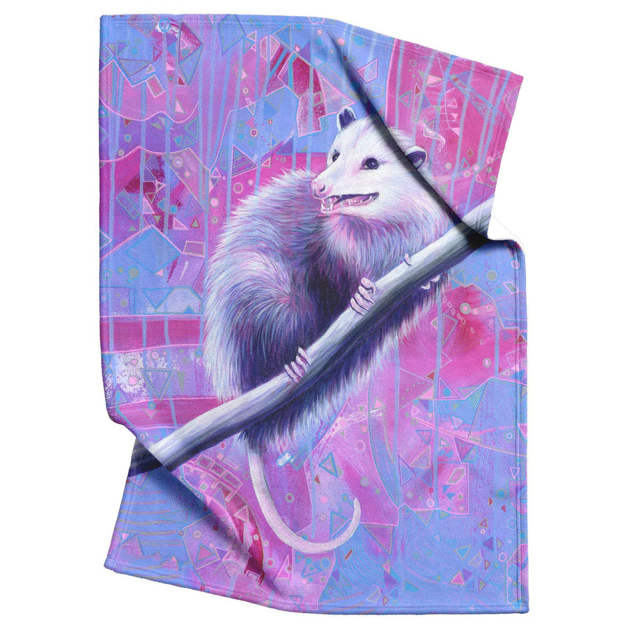 An Opossum Fleece Blanket featuring an opossum perched on a branch, with vibrant pink and purple abstract patterns in the background.