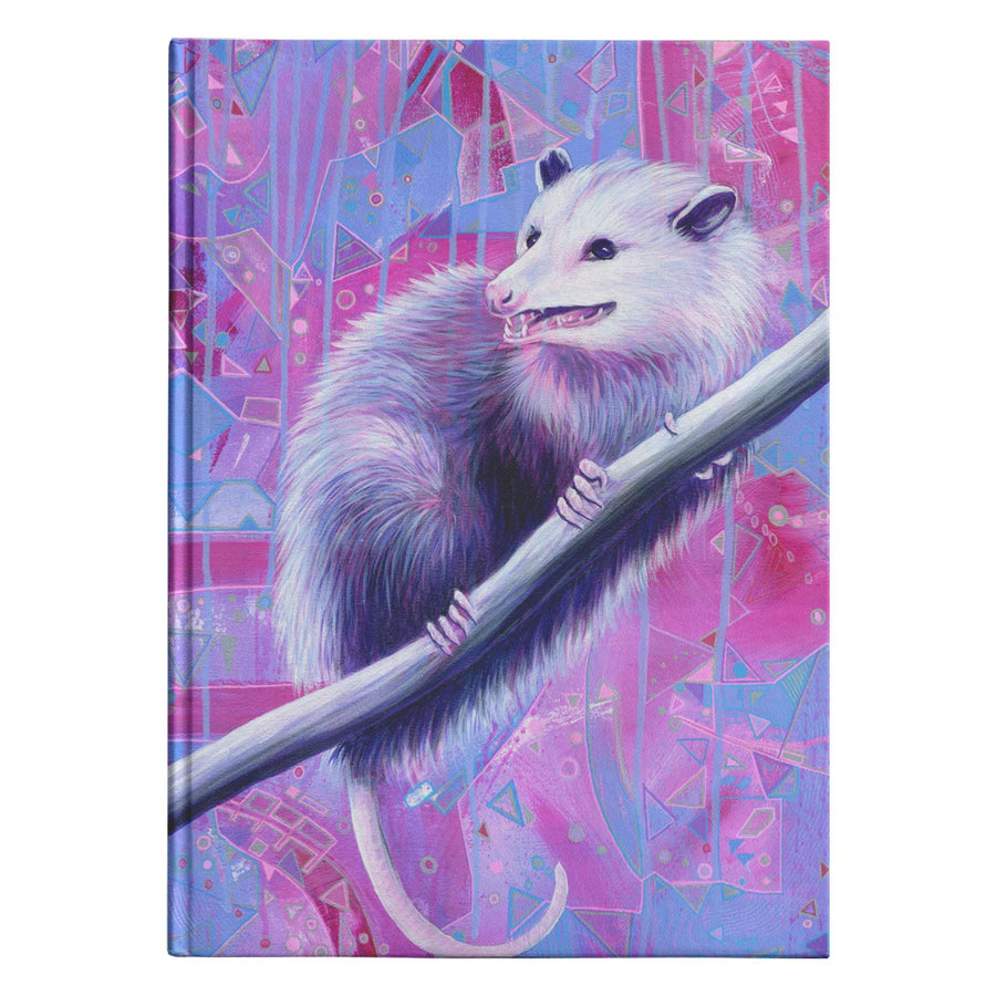 A white Opossum Journal showcasing a possum clinging to a branch against a geometric, purple-toned background.