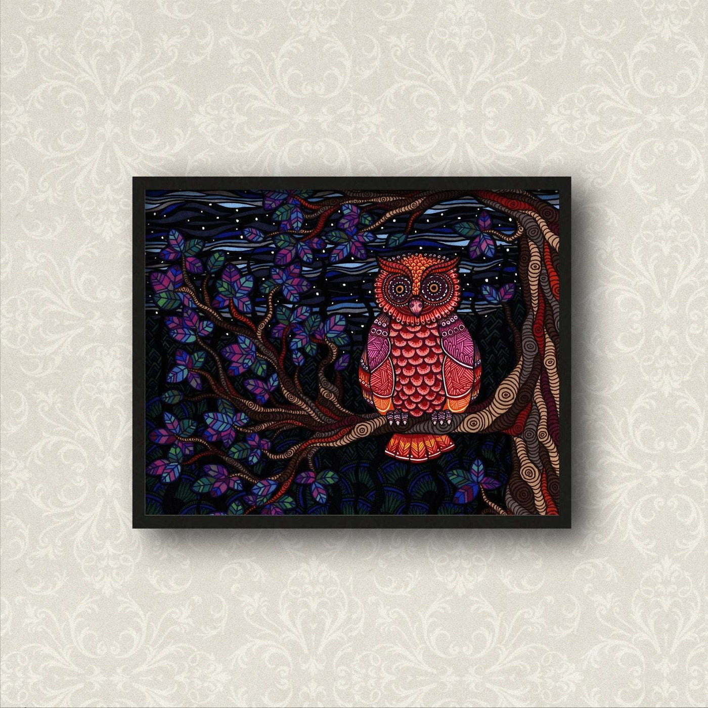 A vibrant fine art print of the Owl Tree by Art by Amanda Lanford, featuring intricate Zentangles and colorful leaves against a dark background, displayed on a patterned wall.