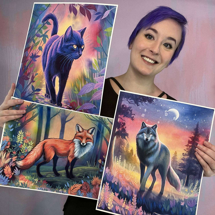 A woman with purple hair displaying three colorful paintings of a cat, a fox, and two wolves in a forest setting from the Twilight Watch - Fine Art Print Bundle.