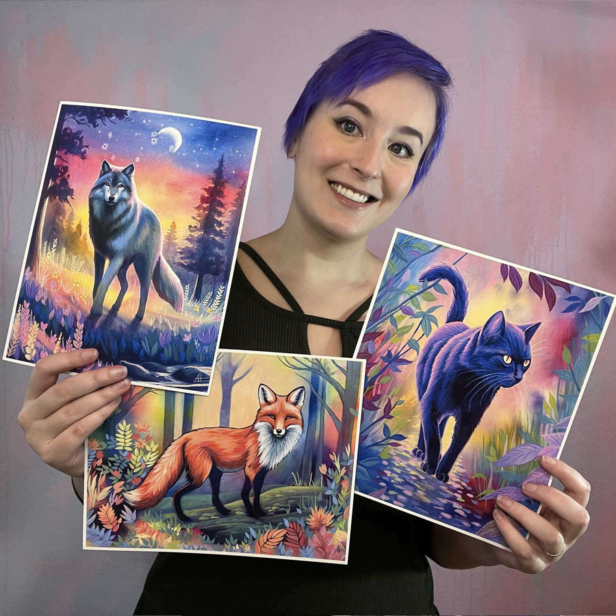 A woman with purple hair smiling at the camera, holding three paintings of animals in a colorful, fantastical style from the Twilight Watch - Fine Art Print Bundle.