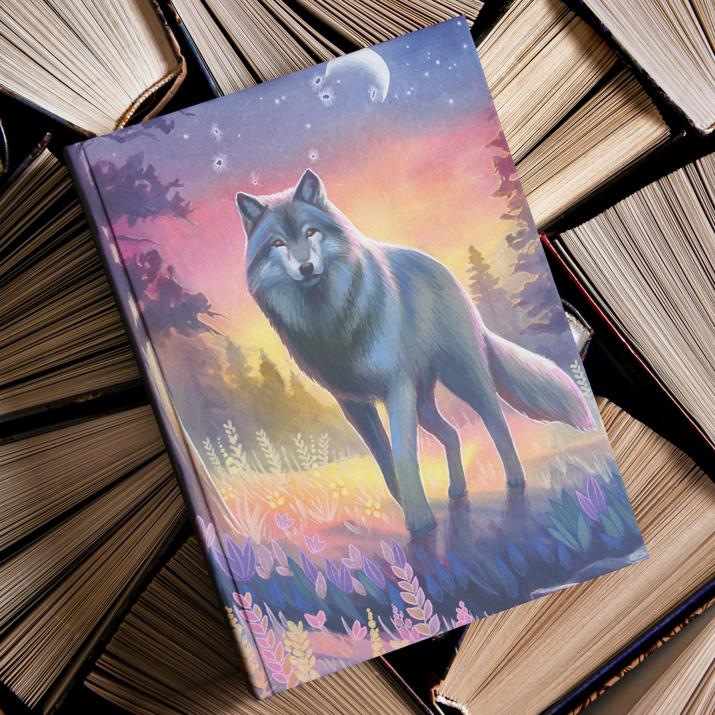 Wolf Journal with a colorful illustrated cover of a wolf standing in a forest at dusk, surrounded by vintage books.